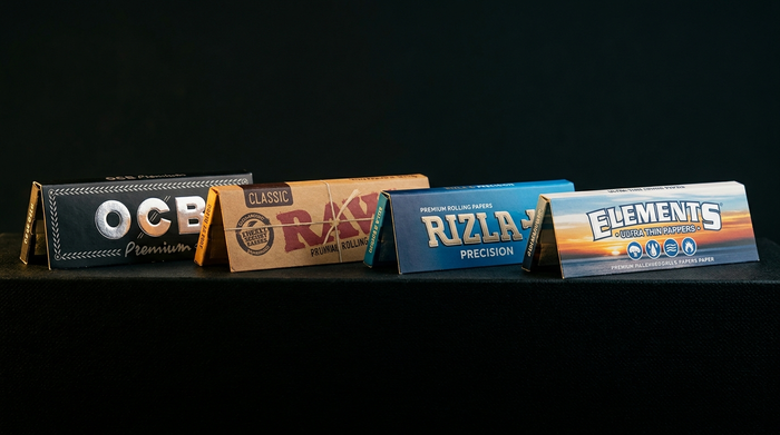 OCB vs RAW vs Rizla vs Elements — rolling papers technical comparison on dark background