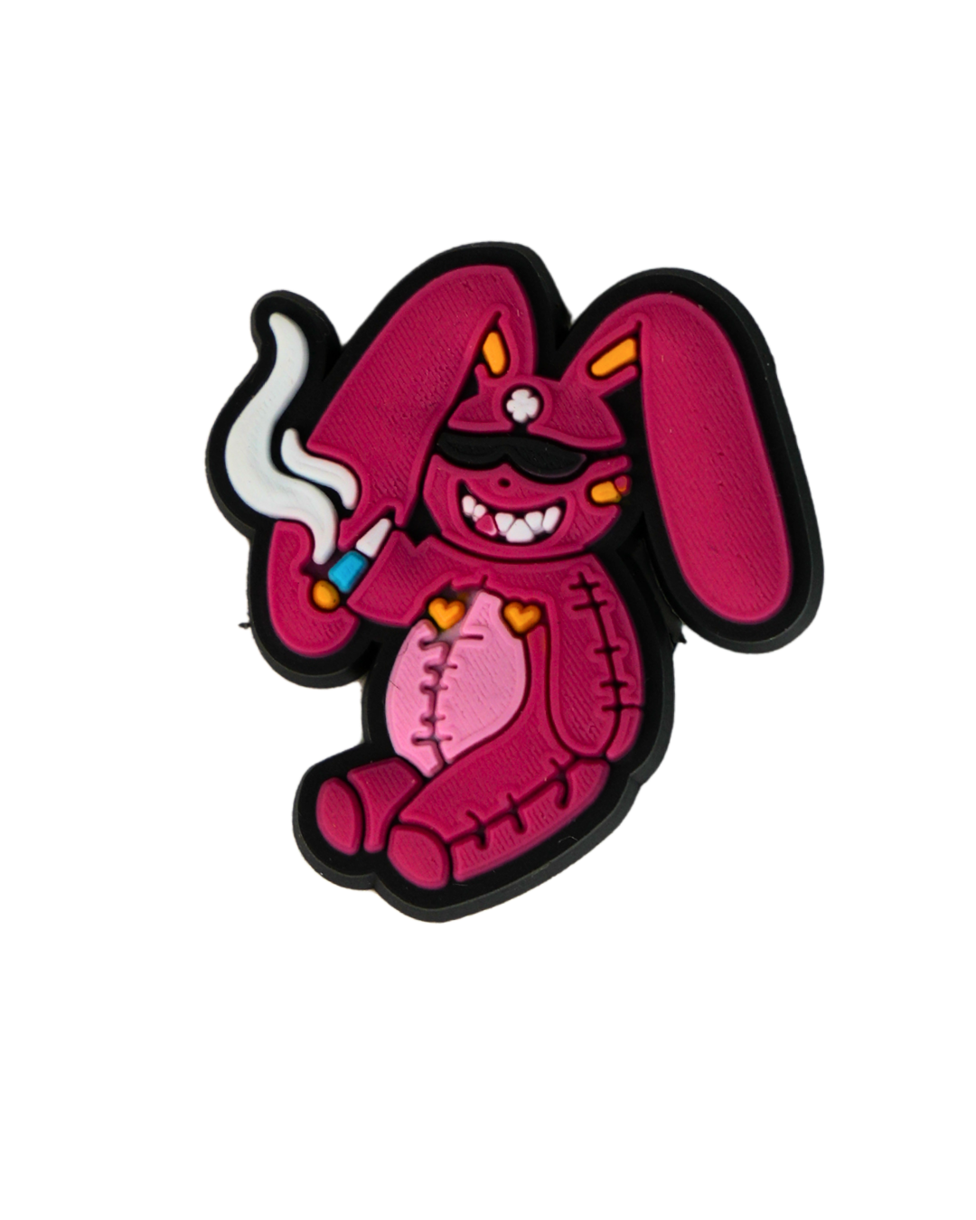 Charm de silicona con diseño de conejo rosa.