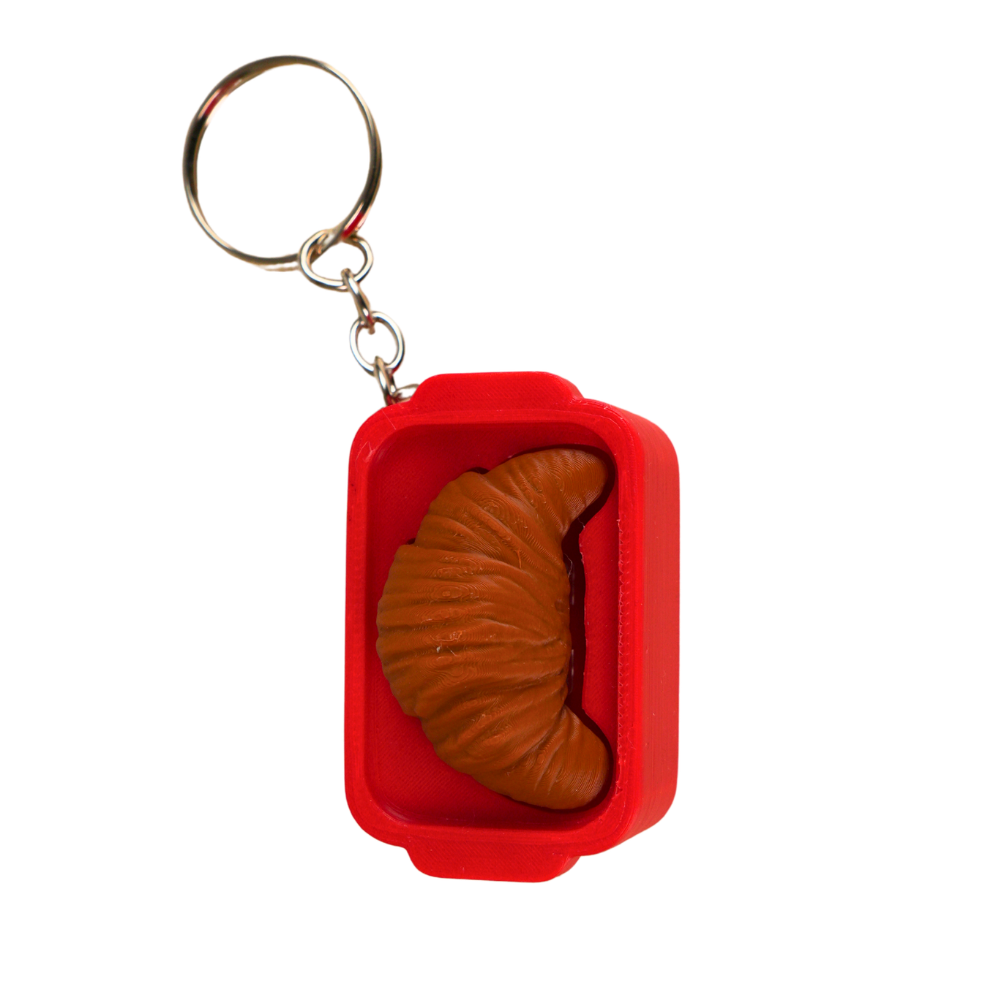 llavero antiestrés beetle print croissant vista lateral dentro de caja diseño compacto