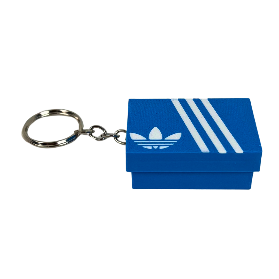 Llavero clicker Beetle Print con diseño de caja de zapatillas azul y franjas blancas, modelo Retro Stripes en vista principal