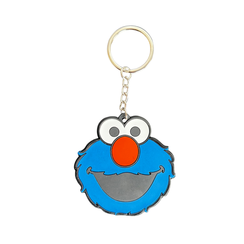 Llavero de silicona cara monstruo azul estilo cartoon con nariz naranja y anilla metálica