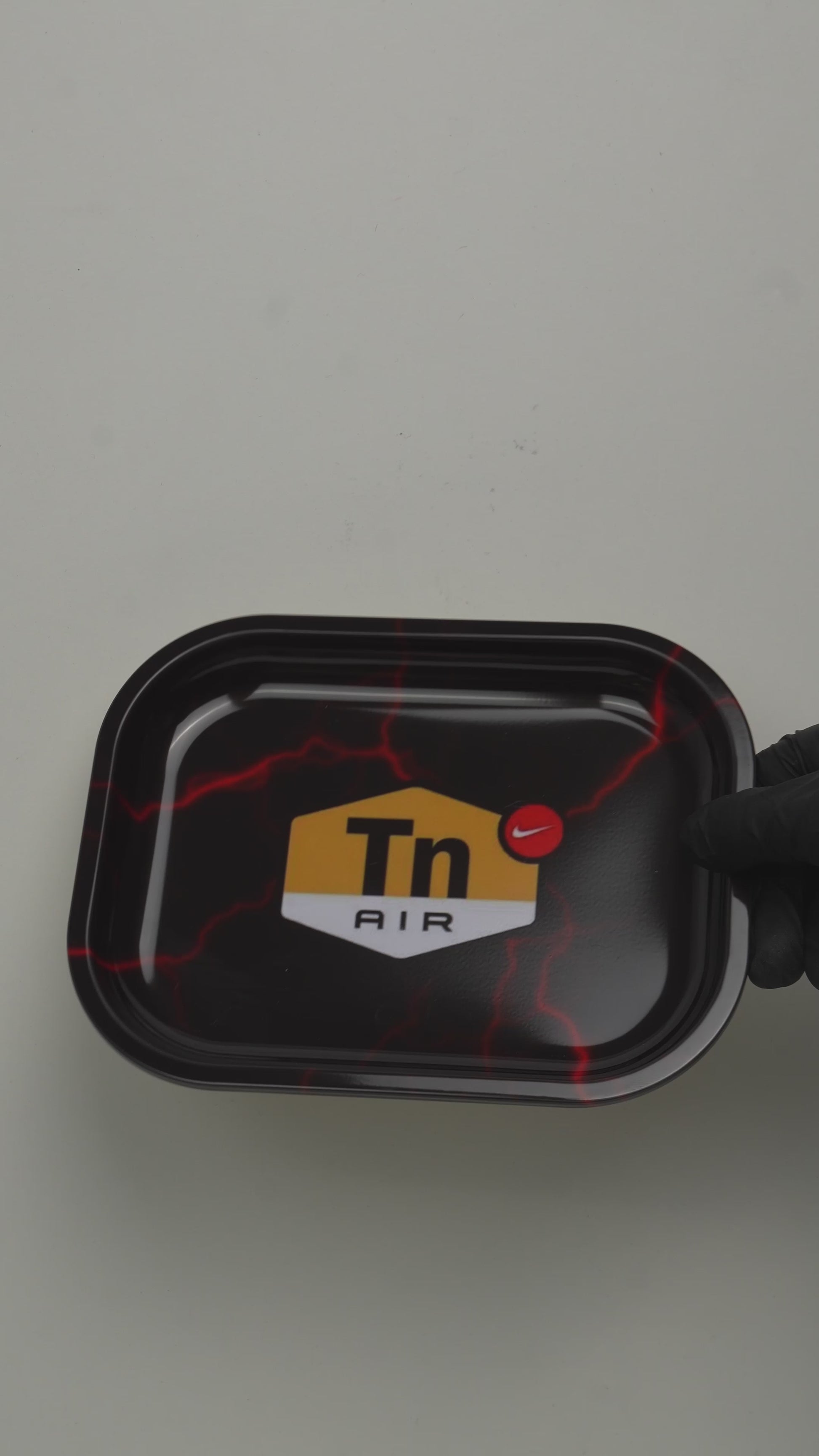 Video showcasing black metal rolling tray with DIR lightning graphic design