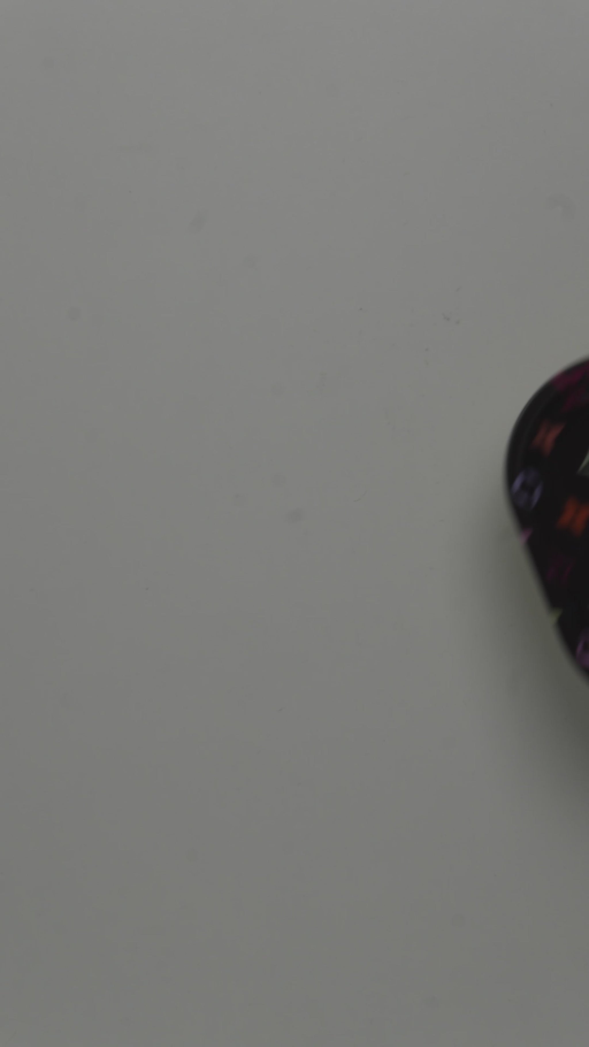 Video showcasing metal rolling tray with multicolor pattern design and glossy finish