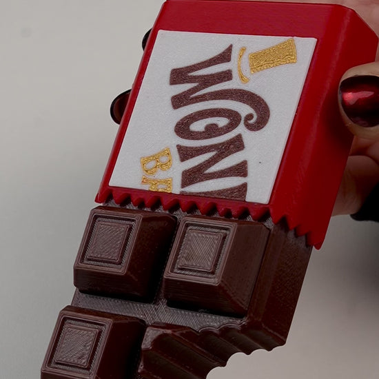 fidget antiestrés beetle print chocolate en uso presionando boton clicker