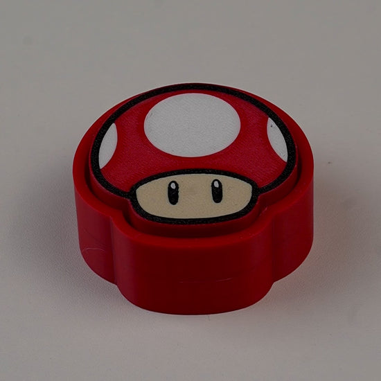 fidget antiestrés beetle print seta roja gaming en uso presionando boton clicker