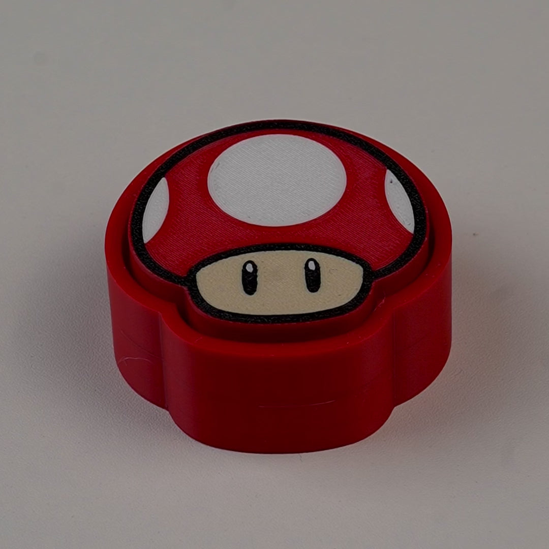 fidget antiestrés beetle print seta roja gaming en uso presionando boton clicker