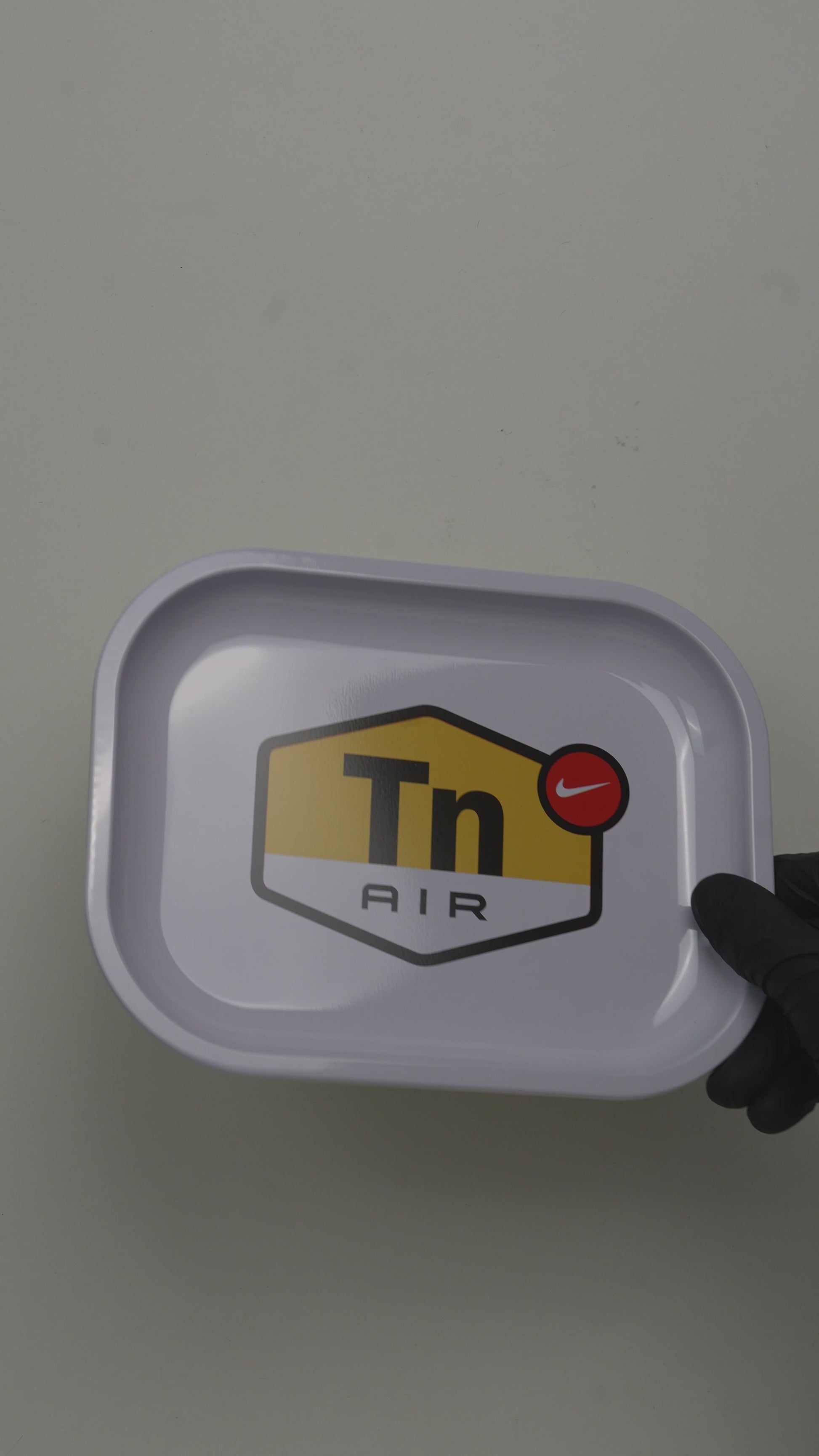 Video showcasing metal rolling tray with minimal DIR signal graphic design
